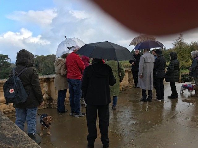 The rain arrives and it's brollies up